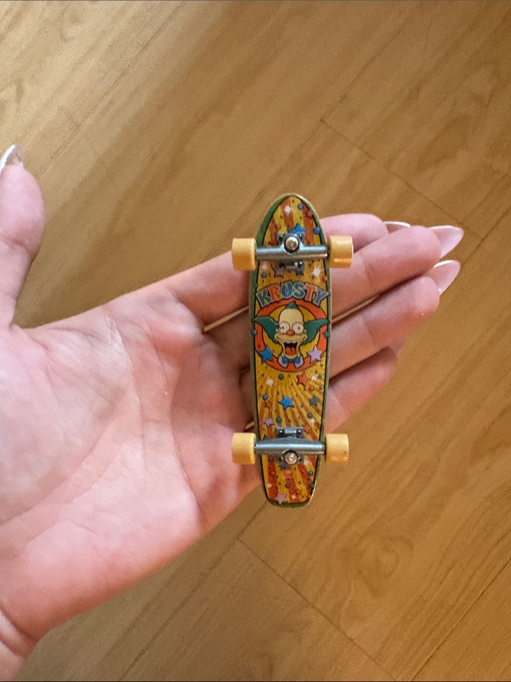 Yellow Mini Fingerboard Skateboard Toy with Cartoon Graphic